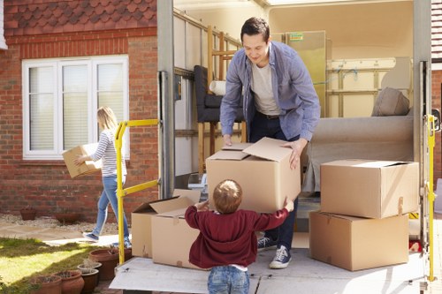 Furniture collection team handling bulky items in a Hydepark residential street